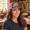 Woman wearing a TRLT Realtree Edge and neon pink trucker hat
